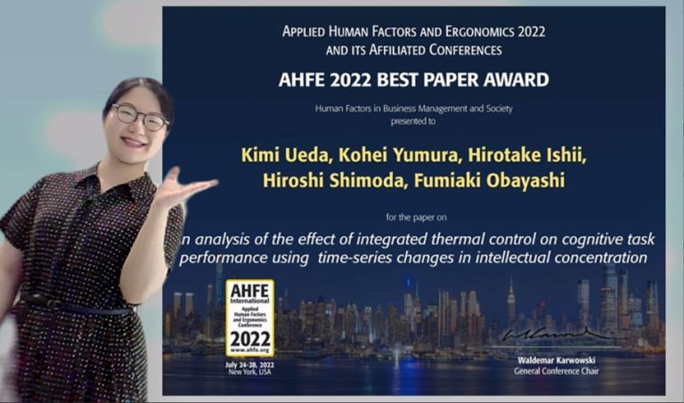 Photo: Assist. prof. Kimi Ueda with the certificate of  AHFE 2022 Best Paper Award